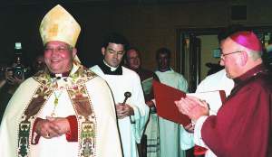 photo of Bishop Morlino, left, being introduced by his predecessor Bishop Bullock, right