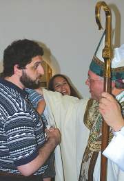 photo of Bishop Morlino greeting Trujillo family after Mass