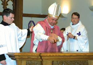 photo of Bishop Morlino anointing new altar with chrism at Blessed Sacrament Parish, Madison