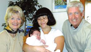 photo of an Elizabeth House resident and her baby with Anne, left, and Fred Grossenbach