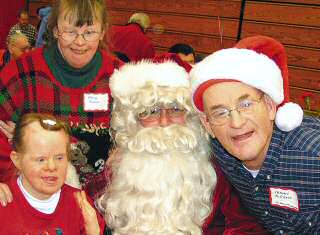 photo of Mary Jane Simdon, Mary Bennin and Frankie McCrath with Santa at Apostolate to the Handicapped Christmas celebration