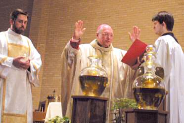 photo of Bishop Robert C. Morlino blessing sacred chrism and oils during the Chrism Mass on March 22