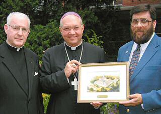 photo of Msgr. Delbert Schmelzer, Bishop Morlino and Kurt Welton with rendering of new monastery