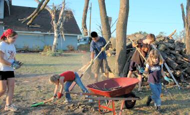 photo of youth cleaning up at the Steckbauer home after the Stoughton tornado