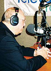 photo of Bishop Robert C. Morlino at microphone as guest on 'The Right Questions' radio talk show