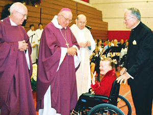 photo of Mary Jane Simdon of Fort Atkinson approaching the altar during the Offertory at Apostolate to the Handicapped's Christmas Mass