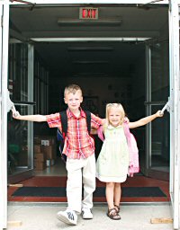 photo of John McBroom and Emily Strenski standing in the doorway at St. Bernard School, Watertown