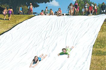 photo of children enjoying the big slide at the Diocesan Family Picnic held recently at the Bishop O'Connor Center in Madison