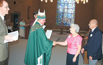 photo of Joyce and Rollie Budnar receiving a certificate from Bishop Robert C. Morlino in honor of their 50th wedding anniversary at the Diocese of Madison's Golden Wedding Anniversary Celebration