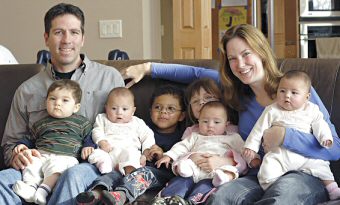 photo of Brian and Tracy Johnson and the six children they have adopted over the past five years, including triplets
