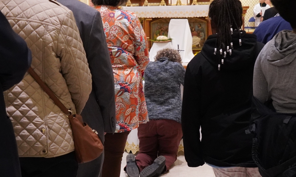 Woman venerating relic of St. John Paul II