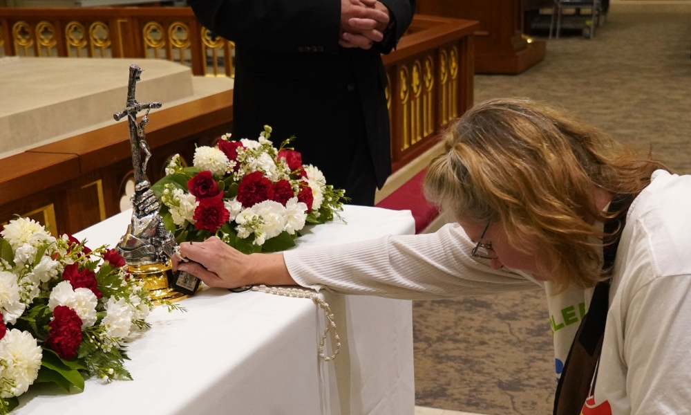 Jubilee pilgrim venerating a relic of St. John Paul II