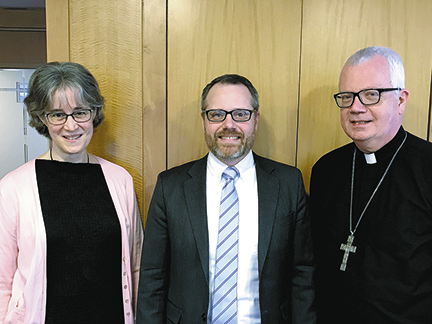 Joan Carey, Dr. John Joy (center), new dean of faculty for St. Ambrose Academy in Madison, and Bishop Donald J. Hying of Madison