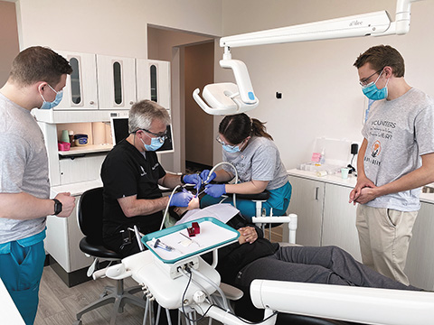Volunteers from Mercy Dental Group work on a patient at their Middleton location during their first “Day of Mercy” dental care event. During the “Day of Mercy,” free dental care was offered to patients who could not otherwise afford dental services. The group plans to continue to offer these events a couple times a year and hopes to expand it into their nine locations.  (Contributed photo)